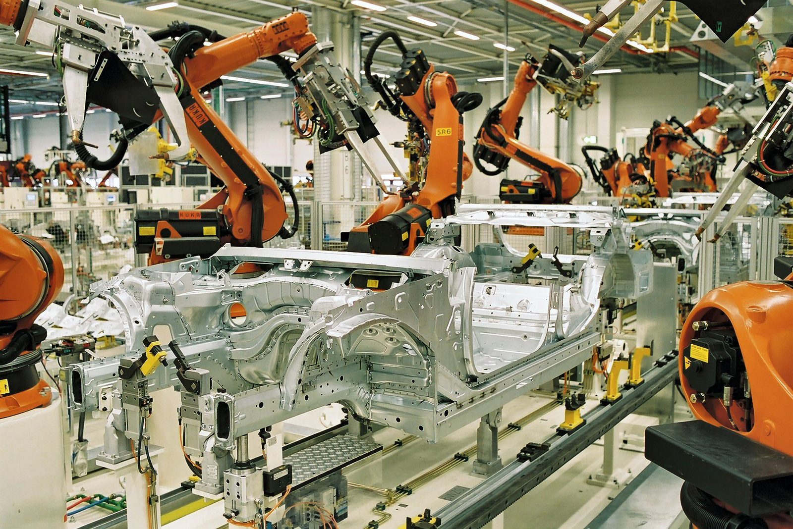Welding robots in a car body shop